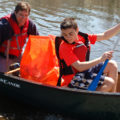Families volunteer together to clean the stream.